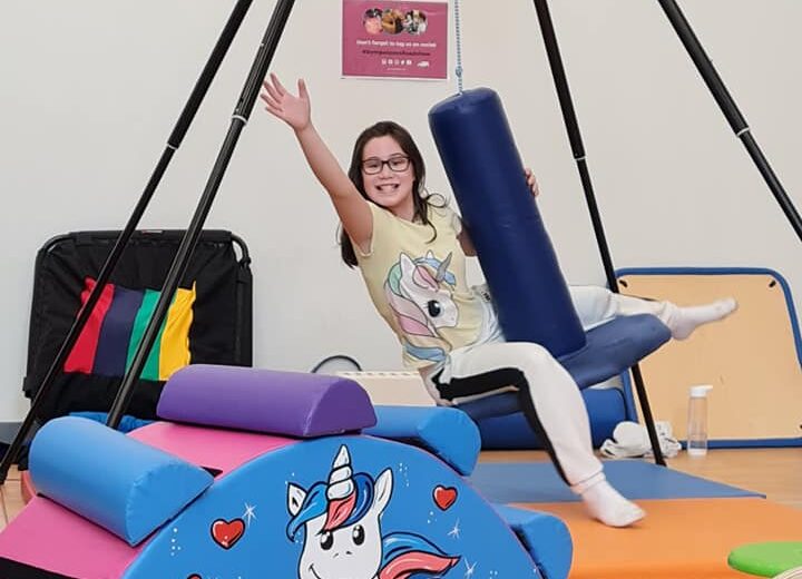 A young girl is enjoying a swing at Gympanzees Pop Up