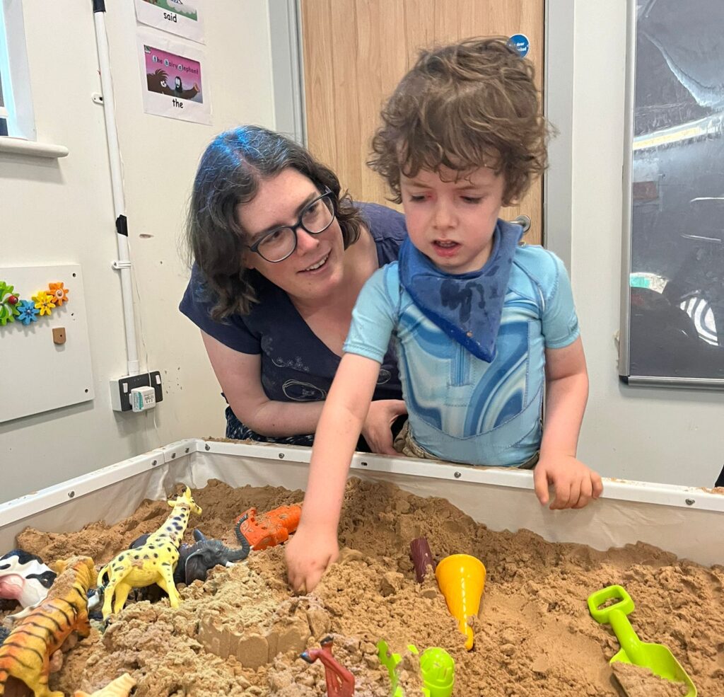 Mother and child playing in the interactive sandpit