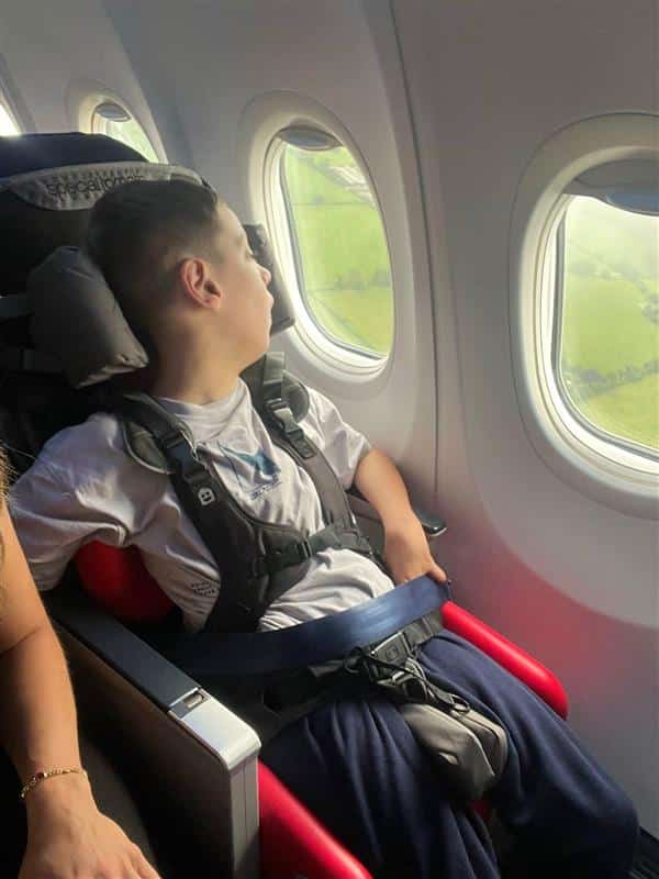 a young child on the airplane in an adaptive seating