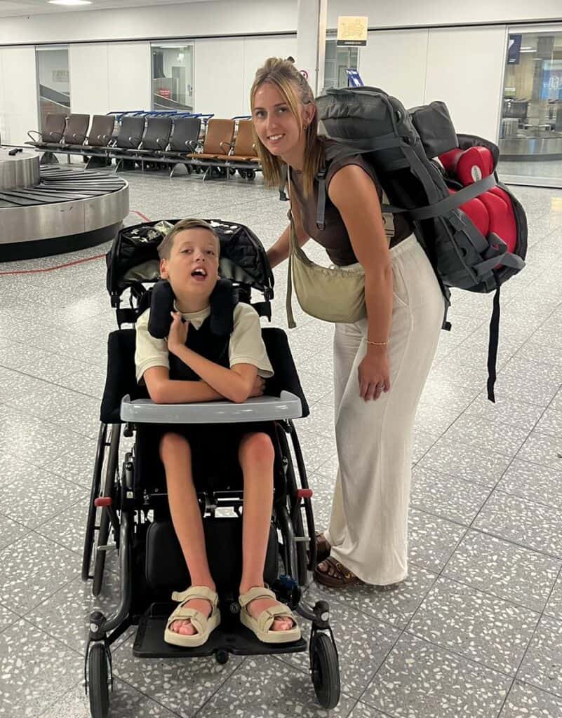An adult and a child in a wheelchair in the airport