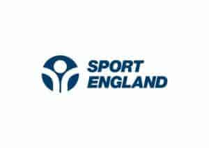 The image is of a logo with a circular design on the left which is shaped like round arms and a circle for a head. The words to the right of this reads, 'Sport England.'