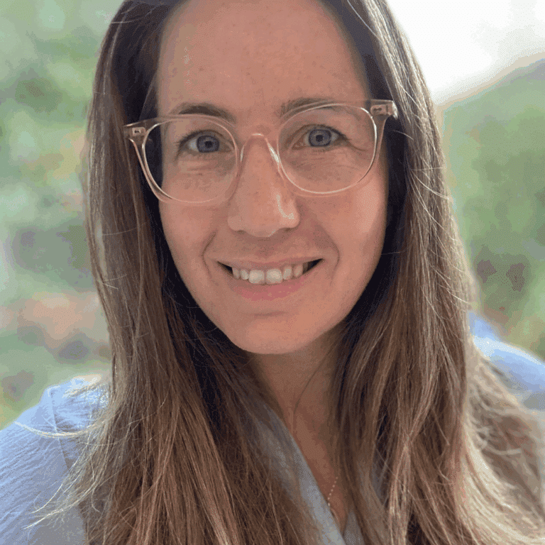 Selfie or a smiling woman with long hair wearing glasses