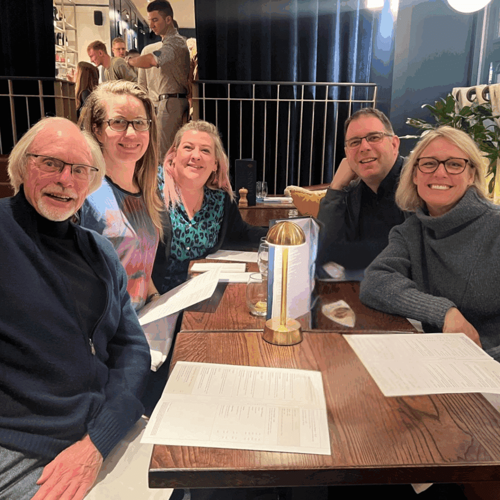 a group of people sitting at the table in a restaraunt