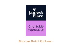 The image is of a dark logo split in two, with the writing in the top readind, 'St James Place' and with the writing in the bottom half which reads, 'Charitable Foundation.' With the words, 'Bronze Build Partner,' underneath.