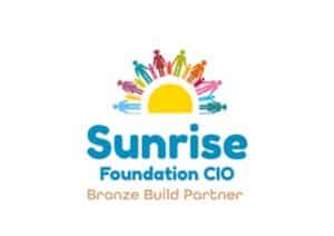 This logo has a bright half circular shape in the middle with different shaped silhouettes of people, of different heights holding hands. Underneath there is dark, bold rounded text that reads,' Sunrise Foundation CIO.' With the words, Brone Build Partner,' underneath.