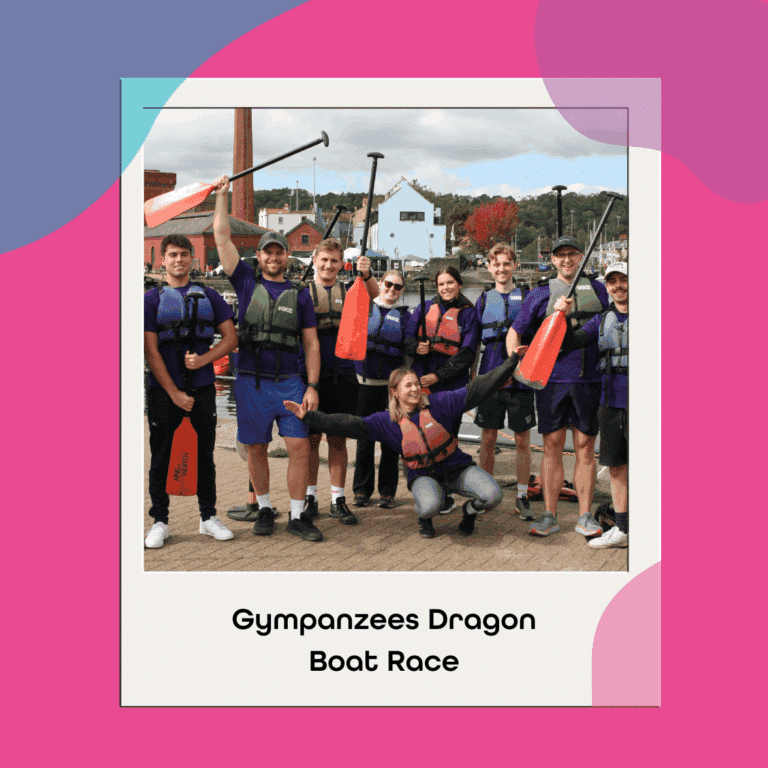 The image is on a colourful background in a polaroid shaped picture with several individuals stood by a harbour in life jackets and holding up paddles, with the words, 'Gympanzees Dragon Boat Race,' underneath.
