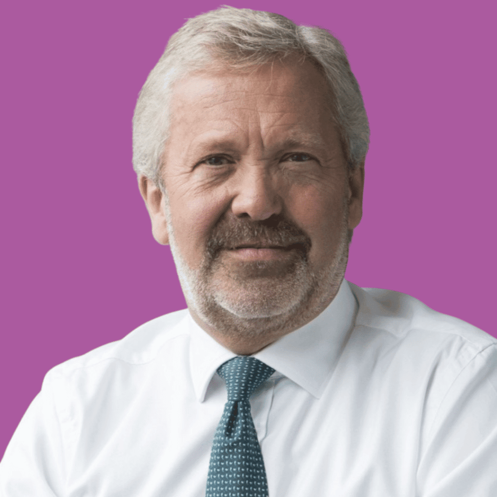 The image is of a man with short hair and a beard, from the shoulders up in a shirt and tie, on a bright background.