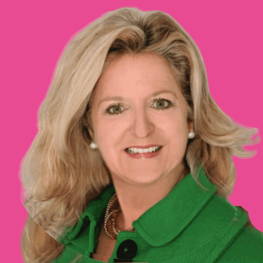 The image is of a woman, with light, mid-length hair, pearl earrings, and a bright coloured, and collared jacket from the shoulders up, smiling into the camera, on a bright background.