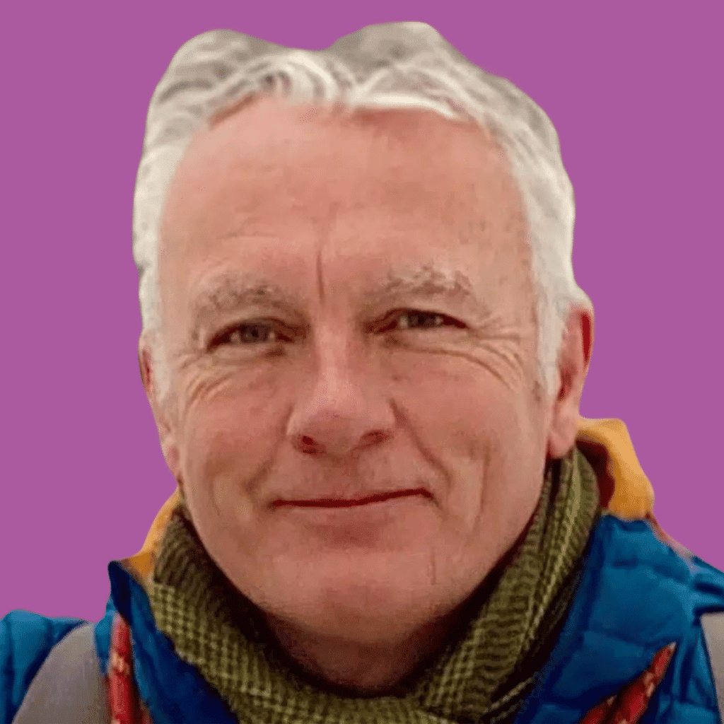 The circular image is of a man from the collar up, in a fleece, smiling into the camera on a bright background.