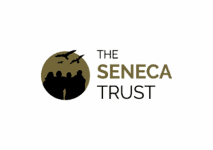The image is of a circular log to the left with a silhouette of a few people with birds flying overhead. Then to the right of this, words stacked reading, 'The Seneca Trust.'