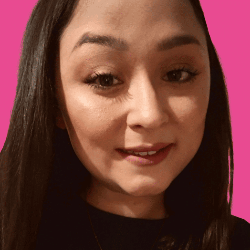 The image is of a woman, with short dark hair, smiling into the camera, on a bright background.
