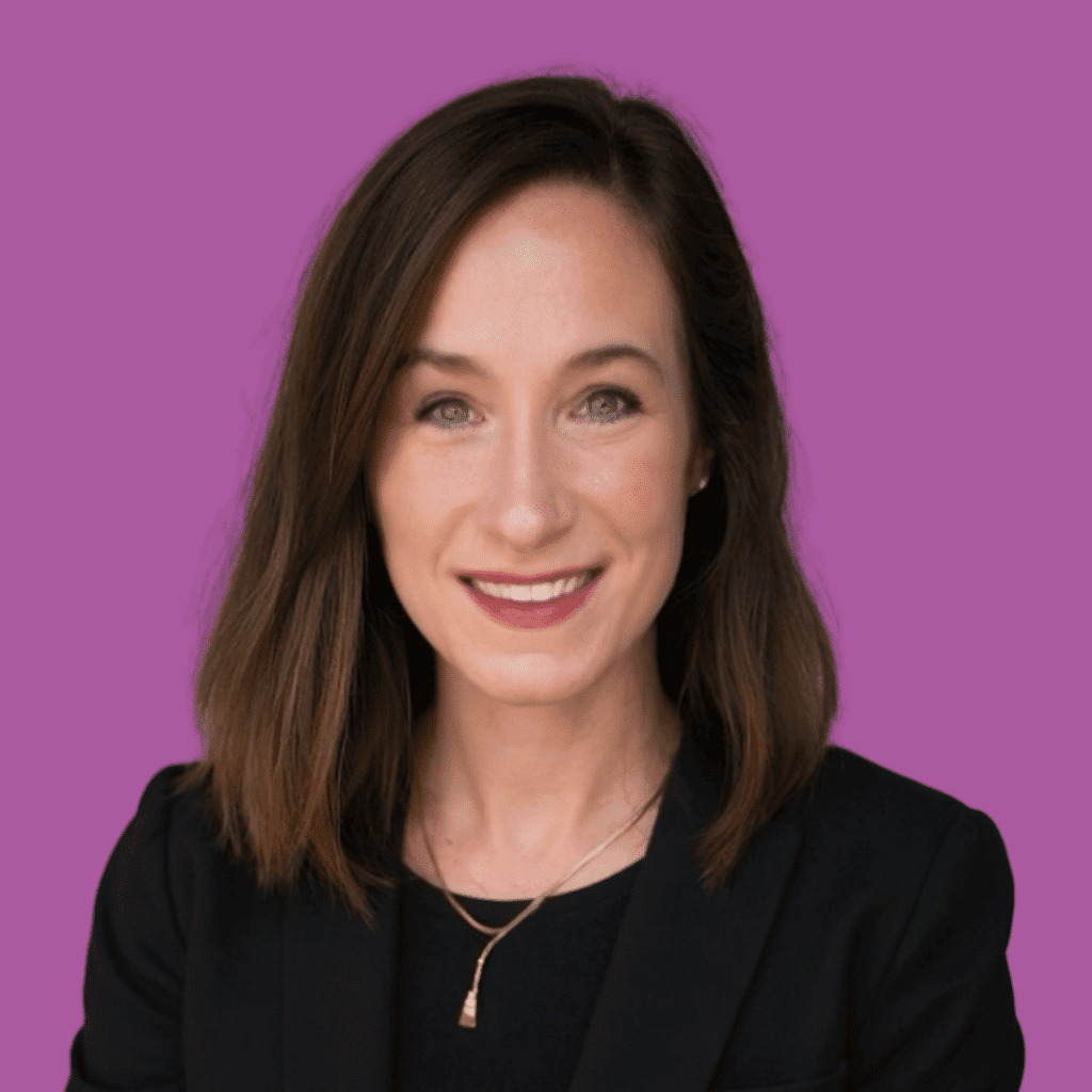 The image is of a woman, with short dark hair, smiling into the camera, on a bright background.