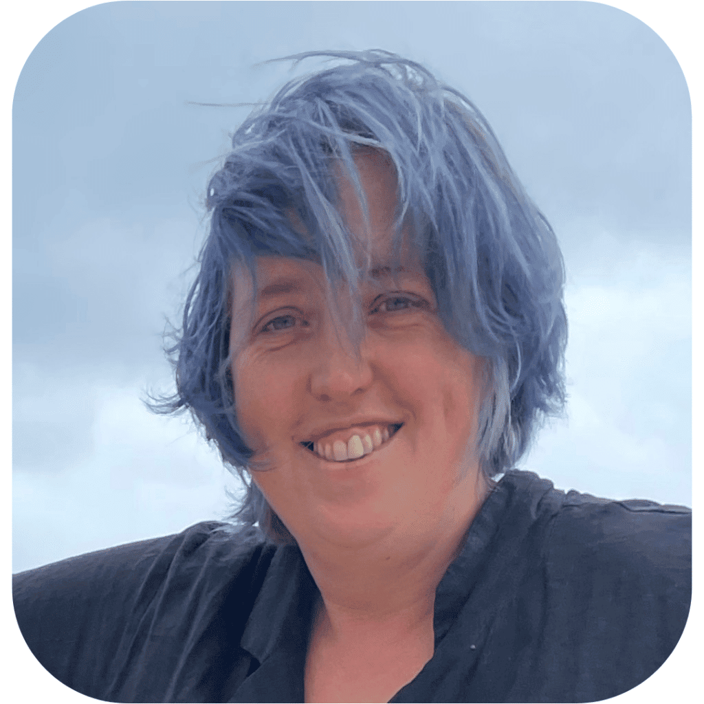 a smiling person with blue hair
