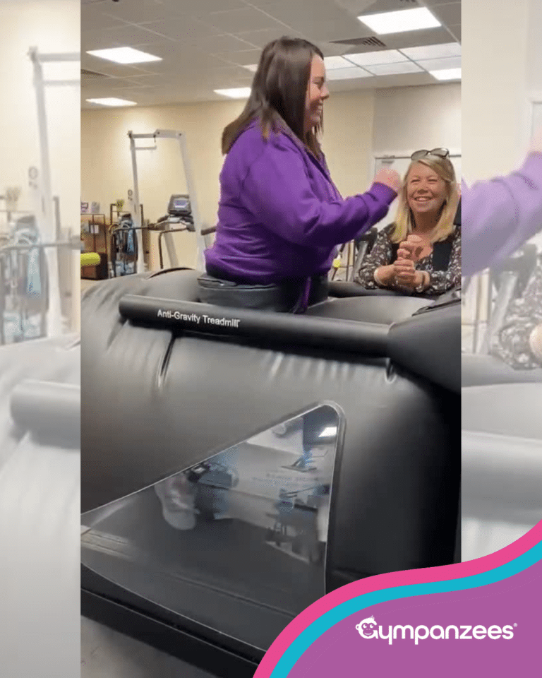 A person in a purple Gympanzees hoodie uses an AlterG Anti-Gravity Treadmill in a gym space. Another person sits nearby, smiling and watching as they try the equipment. The image includes Gympanzees branding in the top left corner with purple, teal and pink curved overlays.