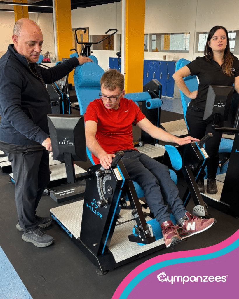 Tom, a young wheelchair user, tries a piece of specialist gym equipment