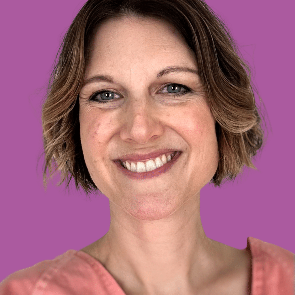 The image is of a woman smiling from the shoulders up with a short bob cut hairstyle.