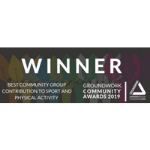 The image is of a darkly coloured background with lighter words on top. The first line is in bold colours reading 'Winner.' Below this to the left reads, in smaller print, 'Best Community Group Construction to sport and Physical Activity. Then to right of this also in smaller print, Groundwork Community Awards 2019.' There is then a triangular lined shape to the right of that.